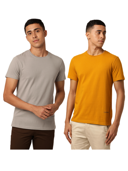 Two men wearing stylish, plain Northmist T-shirts pose against a white background. The man on the left wears an Amity Combo Pack: Organic Crew Neck T-shirt in gray and brown pants, while the man on the right sports an Amity Combo Pack: Organic Crew Neck T-shirt in mustard and beige pants. The short-sleeved T-shirts fit snugly.